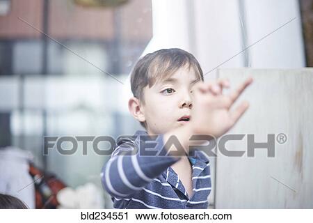 Hispanic boy touching window View Large Photo Image Stock Image - Hispanic boy touching window. Fotosearch