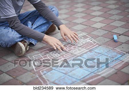 Hispanic boy typing on chalk laptop on sidewalk View Large Photo Image Stock Photo - Hispanic boy typing on chalk laptop on sidewalk. Fotosearch