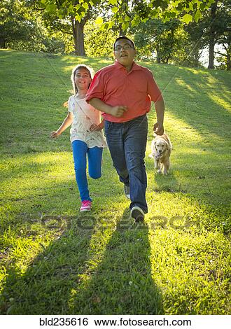 Hispanic brother and sister running with dog on hill View Large Photo Image Stock Photograph - Hispanic brother and sister running with dog on hill. Fotosearch