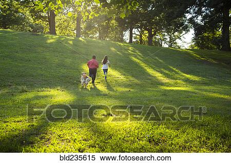 Hispanic brother and sister running with dog on hill View Large Photo Image Stock Photography - Hispanic brother and sister running with dog on hill. Fotosearch