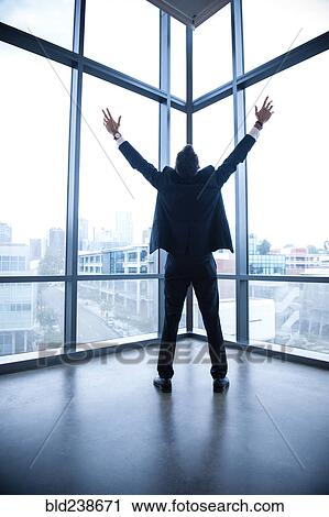 Hispanic businessman celebrating near window View Large Photo Image Stock Image - Hispanic businessman celebrating near window. Fotosearch