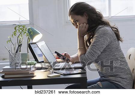 Hispanic businesswoman using technology in office View Large Photo Image Stock Image - Hispanic businesswoman using technology in office. Fotosearch