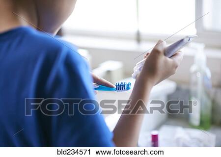 Hispanic by squeezing toothpaste onto toothbrush View Large Photo Image Stock Image - Hispanic by squeezing toothpaste onto toothbrush. Fotosearch
