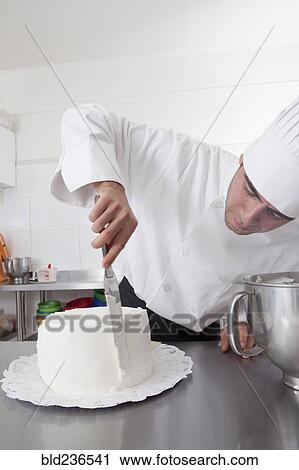 Hispanic chef spreading icing on side of cake View Large Photo Image Stock Image - Hispanic chef spreading icing on side of cake. Fotosearch