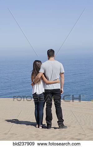 Hispanic couple admiring seascape at beach View Large Photo Image Stock Photo - Hispanic couple admiring seascape at beach. Fotosearch