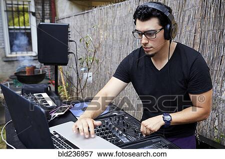 Hispanic dj playing music in backyard View Large Photo Image Stock Photo - Hispanic dj playing music in backyard. Fotosearch
