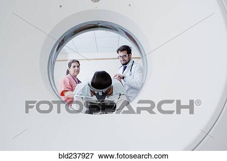 Hispanic doctor and nurse preparing patient for scanner View Large Photo Image Stock Photo - Hispanic doctor and nurse preparing patient for scanner. Fotosearch