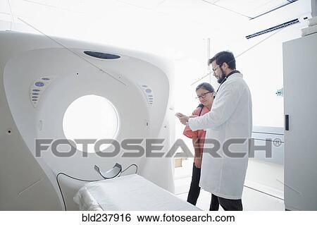 Hispanic doctor and nurse talking near scanner View Large Photo Image Stock Photograph - Hispanic doctor and nurse talking near scanner. Fotosearch