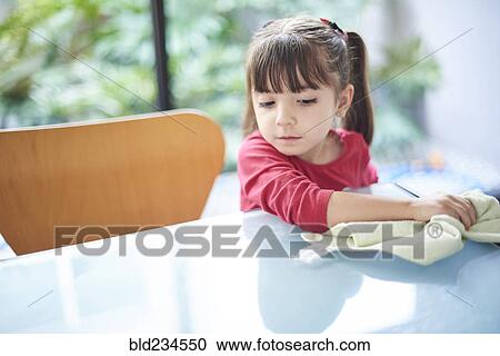 Hispanic girl cleaning table with towel View Large Photo Image Stock Image - Hispanic girl cleaning table with towel. Fotosearch