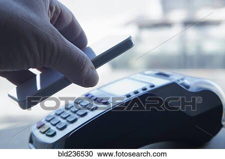 Hispanic man paying with smart phone View Large Photo Image Stock Image - Hispanic man paying with smart phone. Fotosearch