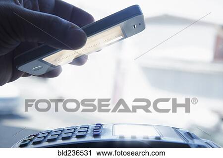 Hispanic man paying with smart phone View Large Photo Image Stock Image - Hispanic man paying with smart phone. Fotosearch