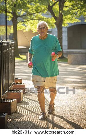 Stock Photo - Hispanic man walking in park. Fotosearch