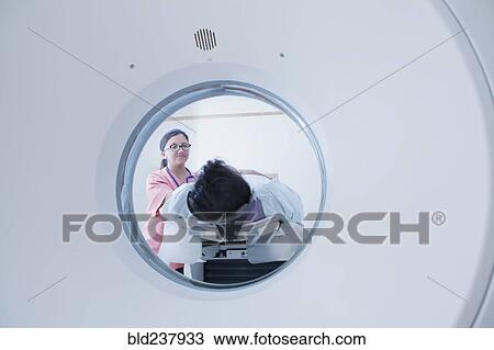 Hispanic nurse comforting patient at scanner View Large Photo Image Stock Image - Hispanic nurse comforting patient at scanner. Fotosearch