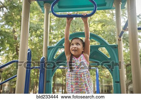 Picture - Hispanic playing on playground. Fotosearch