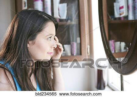 Hispanic woman at bathroom mirror View Large Photo Image Stock Photography - Hispanic woman at bathroom mirror. Fotosearch
