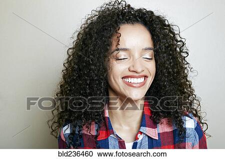 Stock Image - Hispanic woman laughing. Fotosearch