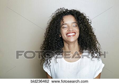 Stock Image - Hispanic woman laughing. Fotosearch
