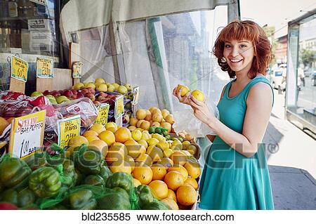 Hispanic woman shopping for lemons at fruit stand View Large Photo Image Stock Photography - Hispanic woman shopping for lemons at fruit stand. Fotosearch