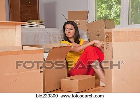 Hispanic woman sitting on floor with moving boxes View Large Photo Image Stock Image - Hispanic woman sitting on floor with moving boxes. Fotosearch