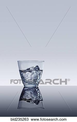 Ice cube in glass of water View Large Photo Image Stock Image - Ice cube in glass of water. Fotosearch