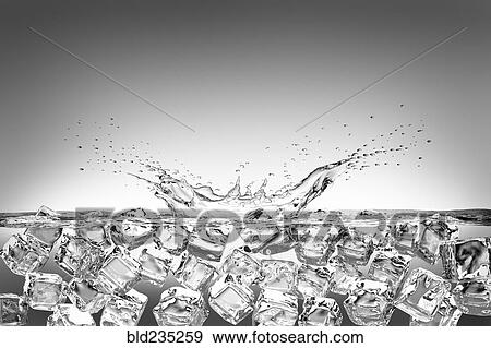 Stock Photo - Ice cubes splashing into water and floating. Fotosearch