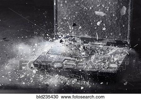 Stock Image - Ice shattering on frozen laptop. Fotosearch