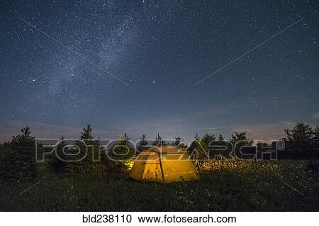 Illuminated camping tent under starry sky View Large Photo Image Stock Image - Illuminated camping tent under starry sky. Fotosearch