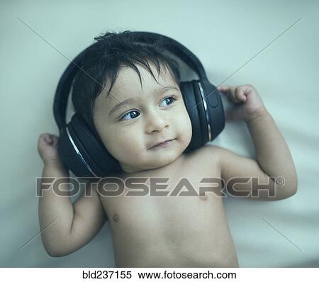 Indian baby boy listening to headphones View Large Photo Image Stock Photography - Indian baby boy listening to headphones. Fotosearch