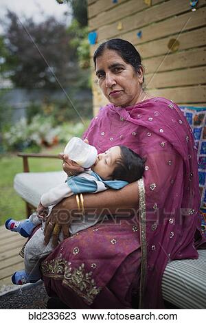 Indian grandmother feeding bottle to grandson View Large Photo Image Stock Image - Indian grandmother feeding bottle to grandson. Fotosearch