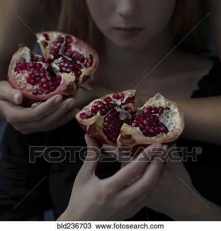 Intertwined Caucasian girls holding sliced pomegranate View Large Photo Image Stock Image - Intertwined Caucasian girls holding sliced pomegranate. Fotosearch