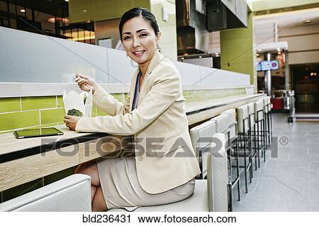 Japanese businesswoman in food court eating food from carton View Large Photo Image Stock Image - Japanese businesswoman in food court eating food from carton. Fotosearch