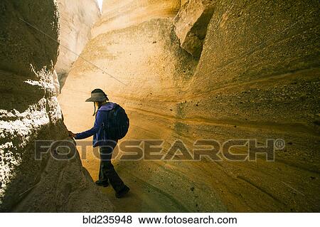 Stock Photo - Japanese woman hiking between canyon walls. Fotosearch