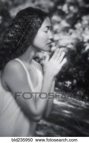Japanese woman praying outdoors View Large Photo Image Stock Image - Japanese woman praying outdoors. Fotosearch
