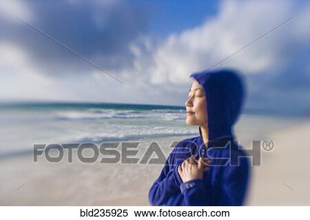 Stock Photography - Japanese woman relaxing on beach. Fotosearch