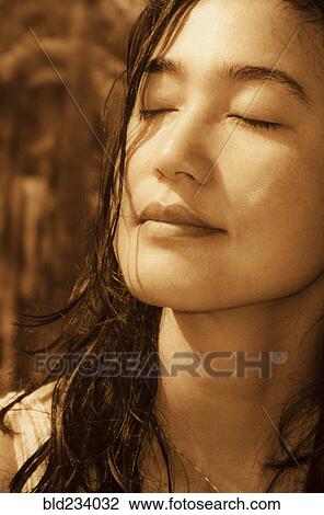 Japanese woman with eyes closed on sunny day View Large Photo Image Stock Image - Japanese woman with eyes closed on sunny day. Fotosearch