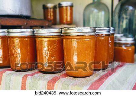 Jars of peach jam on table View Large Photo Image Stock Photography - Jars of peach jam on table. Fotosearch