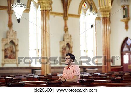 Kneeling Hispanic man praying in church pew View Large Photo Image Stock Image - Kneeling Hispanic man praying in church pew . Fotosearch
