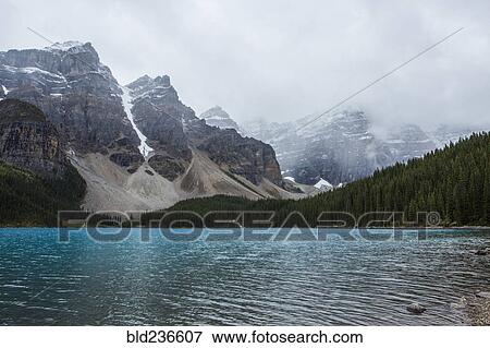 Stock Photo - Lake at foggy mountain. Fotosearch