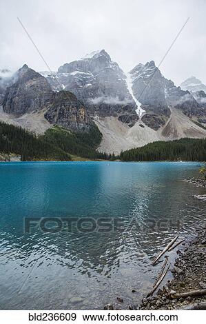 Stock Photo - Lake at foggy mountain. Fotosearch