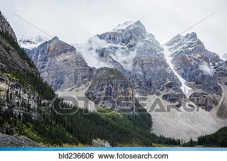 Stock Photograph - Lake at foggy mountain. Fotosearch