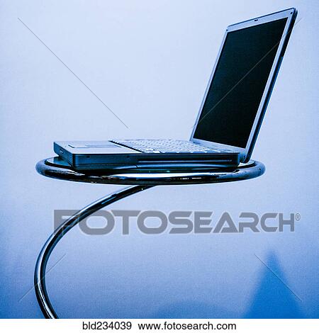 Laptop on round table View Large Photo Image Stock Photo - Laptop on round table. Fotosearch