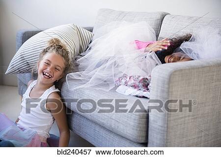 Laughing girls playing on sofa View Large Photo Image Stock Photo - Laughing girls playing on sofa. Fotosearch