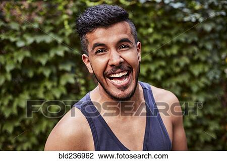 Laughing Middle Eastern man wearing tank-top View Large Photo Image Stock Image - Laughing Middle Eastern man wearing tank-top. Fotosearch
