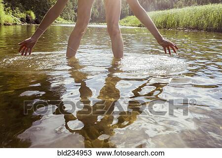 Legs and arms of Caucasian woman wading in river View Large Photo Image Stock Image - Legs and arms of Caucasian woman wading in river. Fotosearch