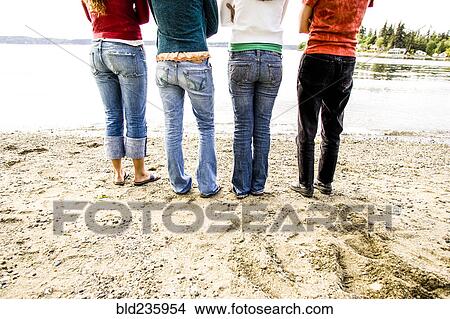 Legs of girls standing on beach View Large Photo Image Picture - Legs of girls standing on beach. Fotosearch