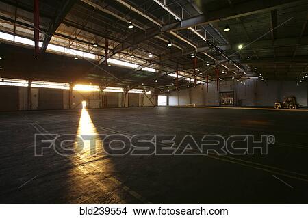Light from doorway in vacant warehouse View Large Photo Image Picture - Light from doorway in vacant warehouse. Fotosearch