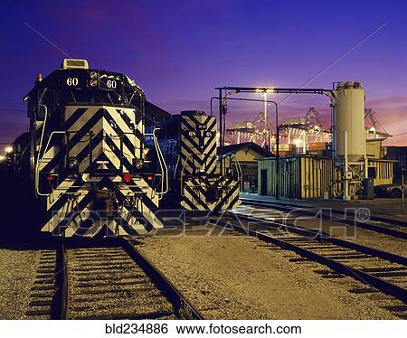 Locomotive on train tracks View Large Photo Image Stock Photograph - Locomotive on train tracks. Fotosearch