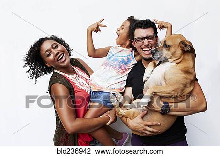 Man and woman holding daughter and dog View Large Photo Image Stock Image - Man and woman holding daughter and dog. Fotosearch