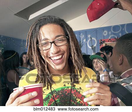 Man drinking at party with friends View Large Photo Image Stock Image - Man drinking at party with friends. Fotosearch