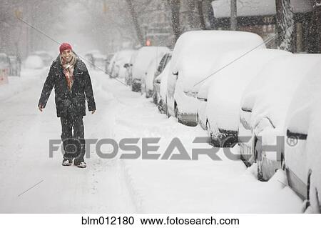 Man enjoying snow in city and walking in street View Large Photo Image Stock Image - Man enjoying snow in city and walking in street. Fotosearch